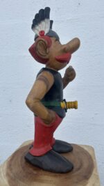 Gros plan sur le visage d’Astérix en bois, avec casque ailé sculpté avec précision